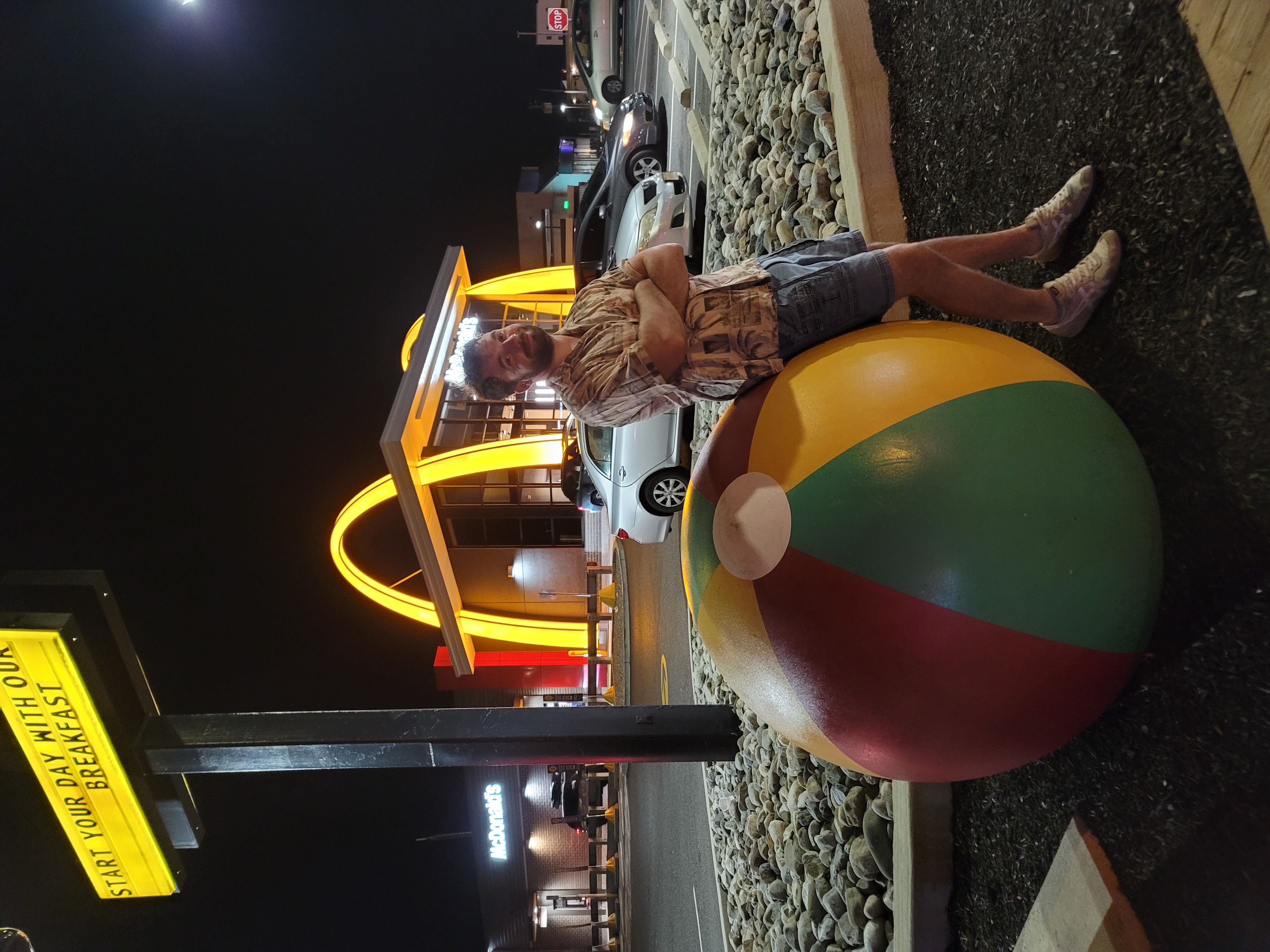 James chilling on a beachball outside of a Mcdonalds